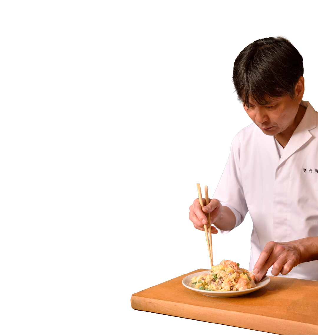 写真：料理を盛り付ける笠原将弘シェフ